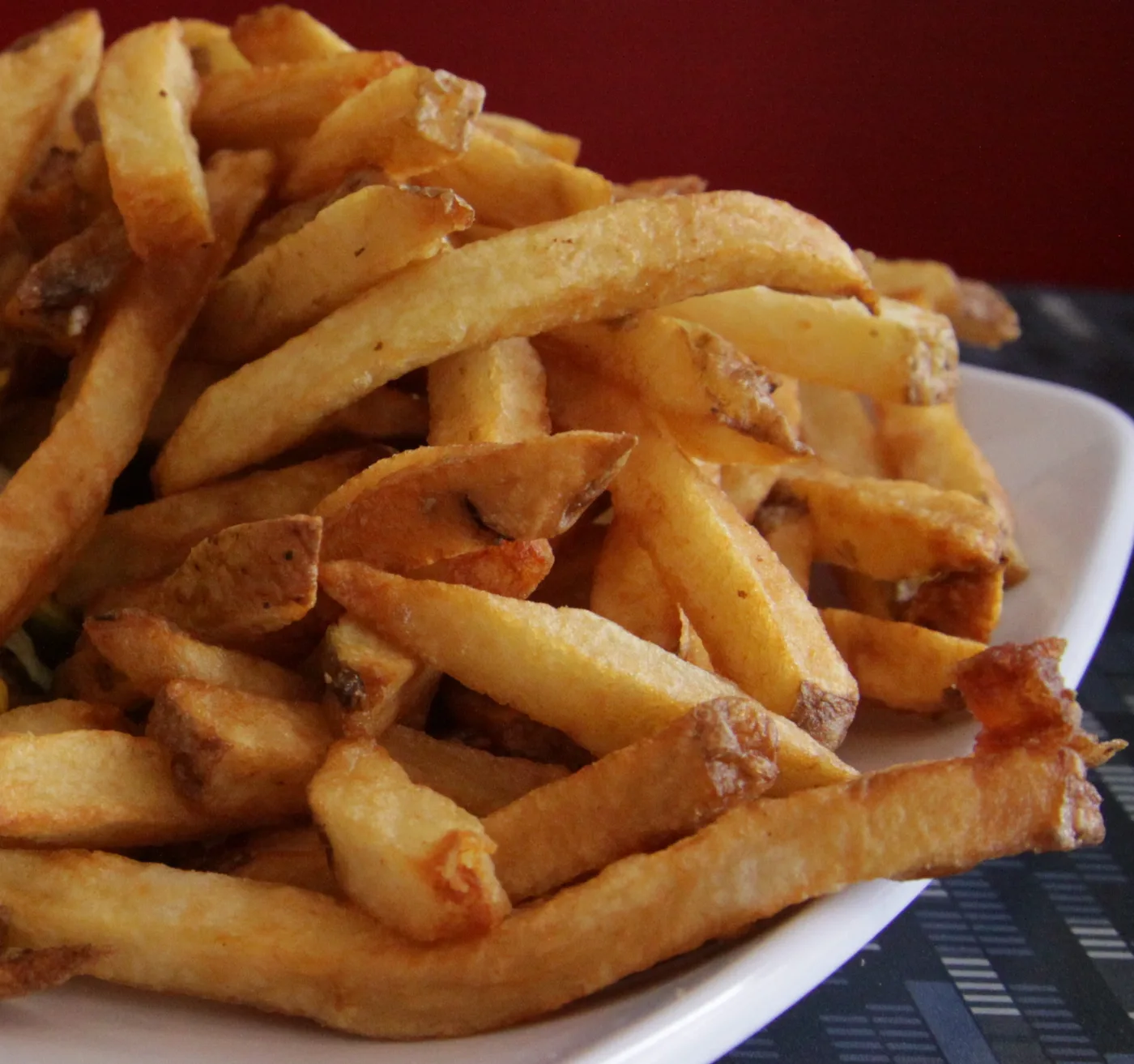 A plate piled with golden house made fries