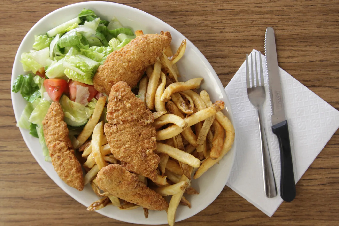 Chicken fingers with fries and a side salad
